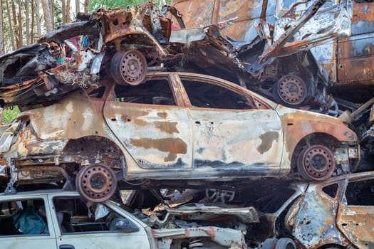 Russian invasion of Ukraine in 2022, destroyed and burned cars. Cars were beaten with shrapnel and burned. Irpensky automobile cemetery. The consequences of the war in a peaceful city near Kyiv