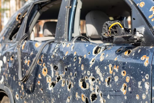 Car riddled with bullets. War of Russia against Ukraine. A car of civilians shot by the Russian military during the evacuation of women and children. Traces of bullets and fragments of shells