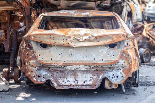Russian invasion of Ukraine in 2022, destroyed and burned cars. Cars were beaten with shrapnel and burned. Irpensky automobile cemetery. The consequences of the war in a peaceful city near Kyiv