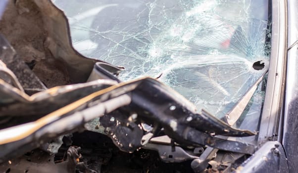 Holes on the windshield of the car, it was shot from a firearm. Bullet holes. Smash car windshield, broken and damaged car. The bullet made a cracked hole in the glass