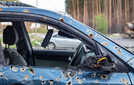Car riddled with bullets. War of Russia against Ukraine. A car of civilians shot by the Russian military during the evacuation of women and children. Traces of bullets and fragments of shells