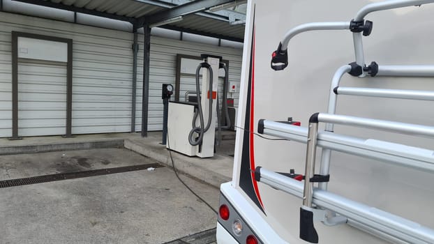 Mobile homes at a gas station here the tire pressure is checked