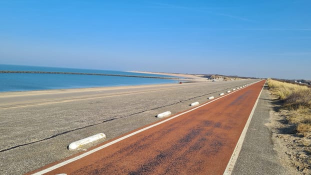 View of the resort of Port Zelande and its surroundings of the lake and dunes under a partly blue sky
