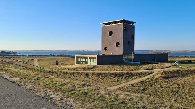 View of the resort of Port Zelande and its surroundings of the lake and dunes under a partly blue sky