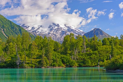 Glaciated Mt Redoubt Volcano Looming in the Distance over Crescent Lake in Lake Clark National Park in Alaska