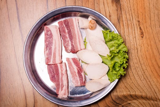Raw pork on plate, Korean traditional style fresh pork beef belly BBQ, Japanese meat hot pot or Shabu in the restaurant, barbecue food