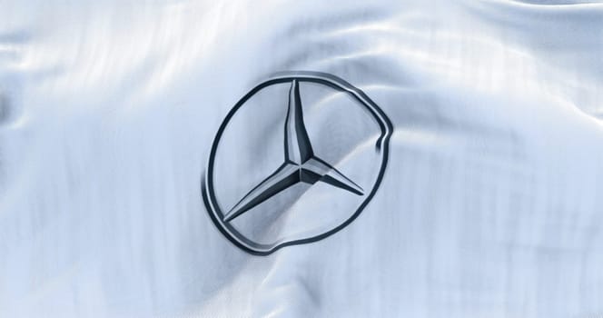 Stuttgart, Germany, June 2022: White flag with the Mercedes-Benz logo waving in the wind.