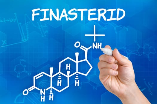 Hand with pen draws chemical structural formula of finasteride
