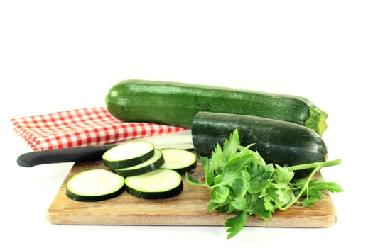 green,raw zucchini against a white background