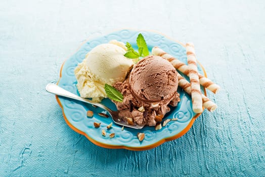 Vanilla and chocolate Ice cream on a blue plate