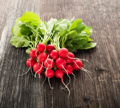 Bunch of fresh red radish on wooden table