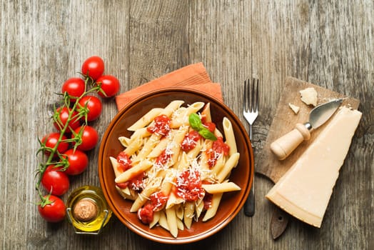 Plate of penne pasta with tomato sauce and parmesan cheese