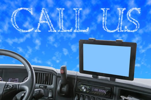 Dashboard of the truck with blue sky in front of the car. The words CALL US are formed from clouds in the blue sky. Navigation display is colored in light blue and is ready for your text.