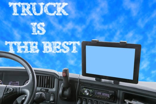 Dashboard of the truck with blue sky in front of the car. The inscription TRUCK IS THE BEST is formed from clouds in the blue sky. Navigation display is colored in light blue and is ready for your text.