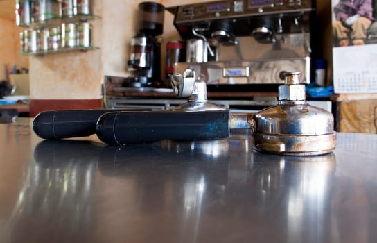 Holder for coffee machine, closeup of expresso accessory recently used