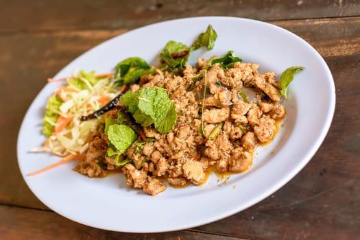 Spicy minced duck salad (with green vegetables and chillies) is northeastern Thai food. It's delicious taste. It's a bit sour and spicy.