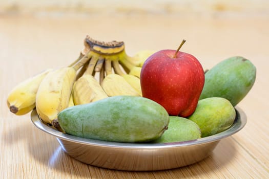 This image is a picture of fruits delicious that is the Banana, Mango and apple.
