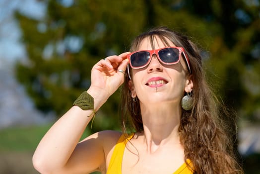 portrait of a young woman with red sunglasses