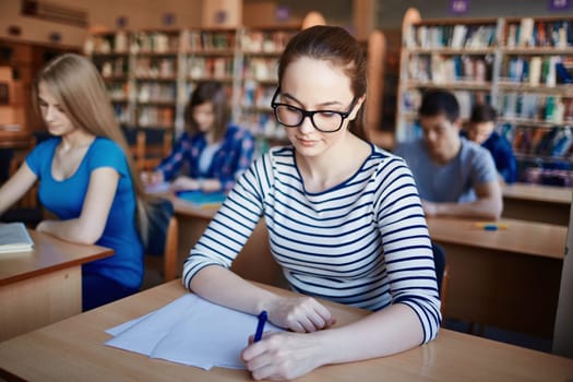 Pretty learner writing test or making notes