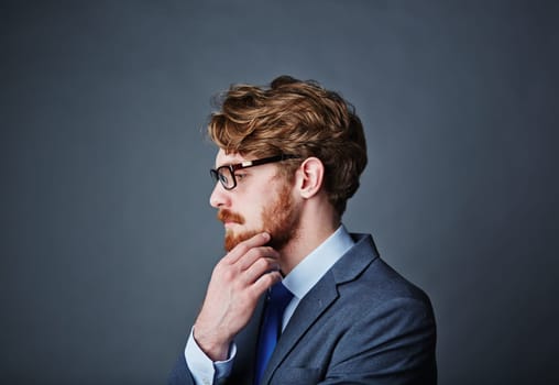 Pensive businessman touching his beard