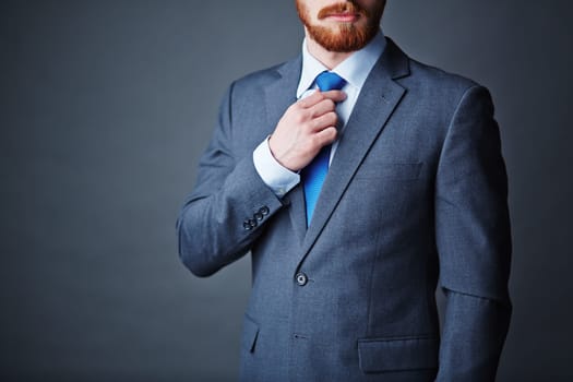 Close-up of young bearded man in elegant suit