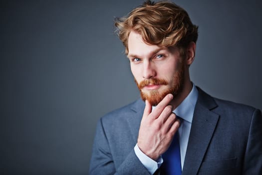 Confident businessman with beard looking at camera