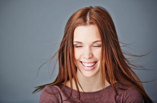 Ecstatic girl with dark long hair and toothy smile