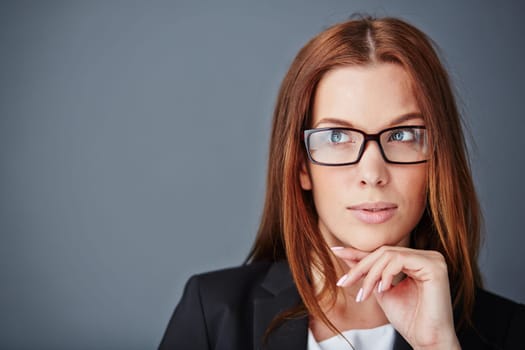 Pensive businesswoman in eyeglasses
