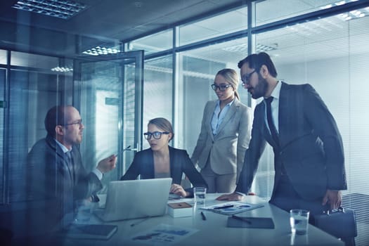 Group of elegant business partners talking at meeting in office