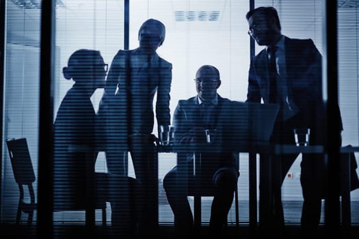 Young co-workers listening to businesswoman ideas in office
