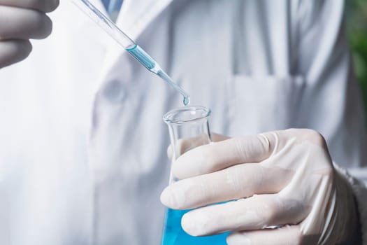 Researcher with glass laboratory chemical test tubes with liquid for analytical, medical, pharmaceutical and scientific research concept.