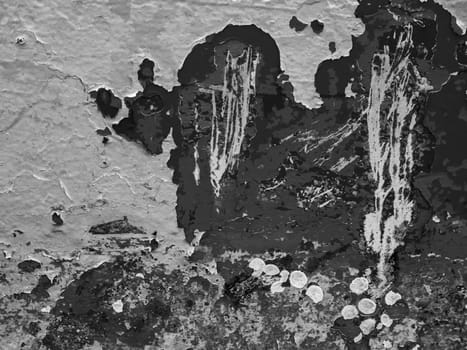 Format-filling view of a metal wall with chipped blue paint in various shades of blue in black and white.