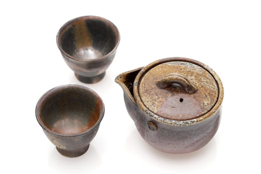 Japanese green tea in a tea set with cup and pot isolated on a white background