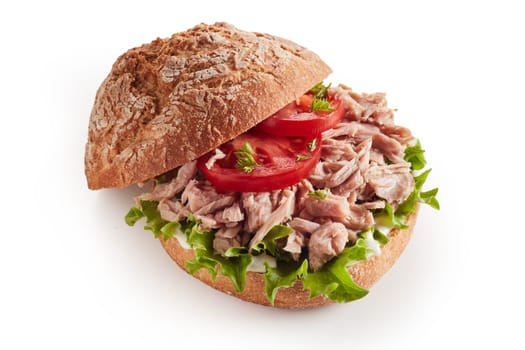 From above of delicious tuna sandwich with fresh lettuce and tomatoes served on white isolated background
