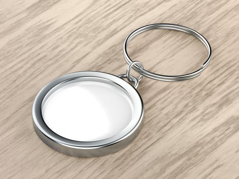 Blank round keychain on wood background