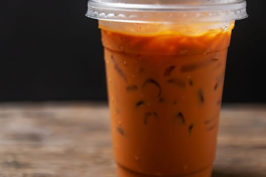 Tea thai, Ice tea milk or Ice milk tea, Sweet drink, Blurred black background
