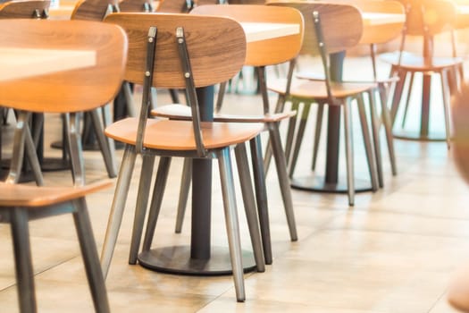 Morning light through rows of  Empty table and chairs in cafe restaurant