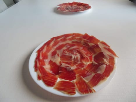 delicious Spanish Iberian ham cut with fantastic aromatic tasty knife