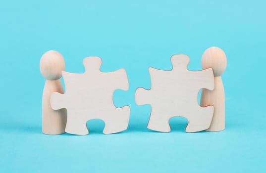 Two men with puzzle pieces built a team, connect the parts together, corporate in teamwork, communication and support concept