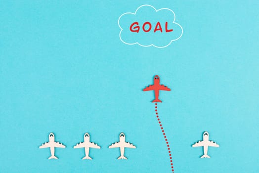 Red airplane is flying to his goal, leadership, courage and winner concept, standing out from the crowd, positive mindset for success in business