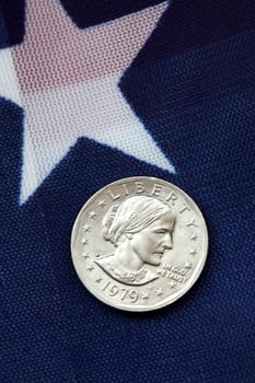 one dollar coin on american flag