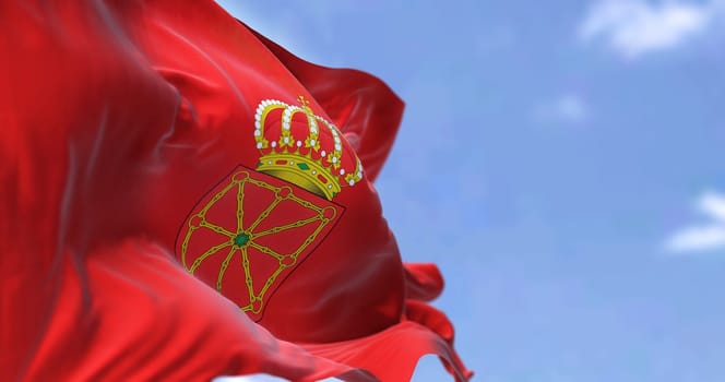 The Navarre flag waving in the wind on a clear day. Navarre is an autonomous community and province in northern Spain