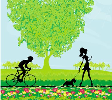relax in the park - man cycling and woman silhouette walking with her dog