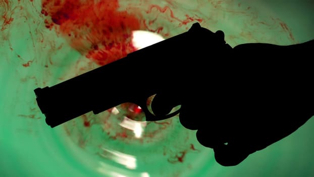 Pistol silhouette agains bloody background