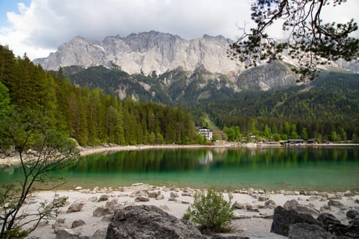 Faboulus landscape of Eibsee Lake with turquoise water in front of Zugspitze summit, Garmisch-Partenkirchen, Bavarian alps, Germany, Europe