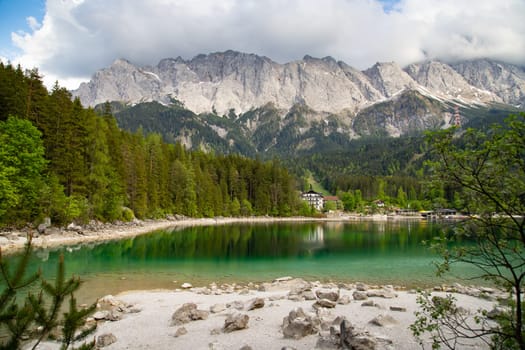 Faboulus landscape of Eibsee Lake with turquoise water in front of Zugspitze summit, Garmisch-Partenkirchen, Bavarian alps, Germany, Europe