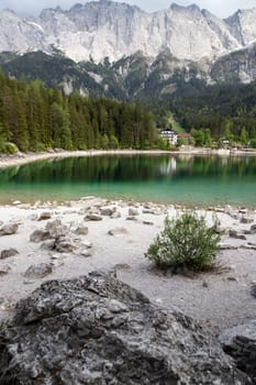 Faboulus landscape of Eibsee Lake with turquoise water in front of Zugspitze summit, Garmisch-Partenkirchen, Bavarian alps, Germany, Europe