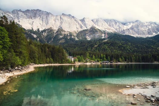Faboulus landscape of Eibsee Lake with turquoise water in front of Zugspitze summit, Garmisch-Partenkirchen, Bavarian alps, Germany, Europe