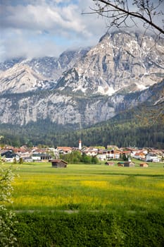 Small village in Austria with the Alps mountains in the background.