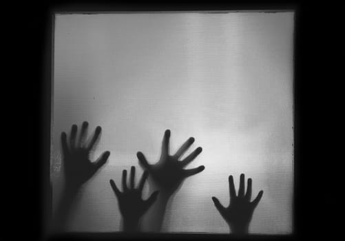Horror, halloween background - Shadowy figure hands behind glass